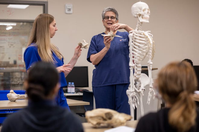 Las cirujanas ortopédicas Kelly Cline, a la izquierda, y Barbara Bergin intentan venir una vez al mes para compartir sus conocimientos de ciencias médicas con estudiantes en una clase de medicina deportiva en la Escuela Ann Richards para Mujeres Jóvenes Líderes,