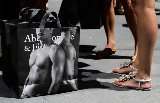 Young women pause with their Abercrombie & Fitch shopping bags on the sidewalk along Fifth Avenue in New York in 2012. (AP Photo/Kathy Willens)