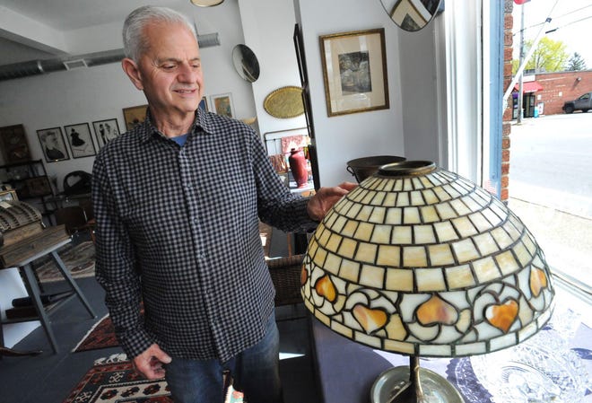 Antiques dealer Tony Venuto details this antique Handel lamp at Bridge Antiques in North Weymouth, Tuesday, April 19, 2022.