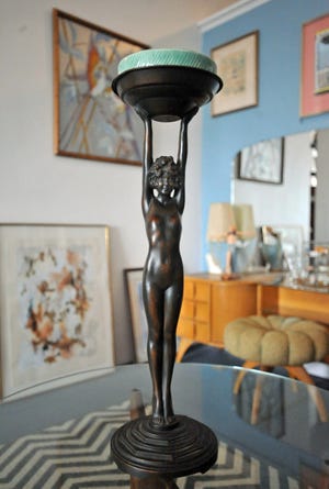 An Art Deco ashtray statue is among the antiques at Bridge Antiques in North Weymouth, Tuesday, April 19, 2022.