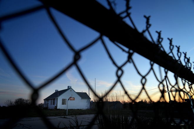 A chain-link fence blocks off Camp Cronin in Narragansett, owned by the City of Providence. Once a haven for city residents looking to beat the summer heat, the property has fallen into disrepair as officials debate its fate.