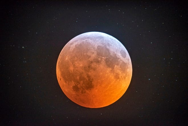 The totally eclipsed moon glows with a reddish color against the background stars in this photo made with Johnny Horne's  12-1/2 inch telescope inside his Stedman observatory early on the morning of Jan. 21, 2019. Another total lunar eclipse will happen for observers in the United States late Sunday night May 15, 2022.