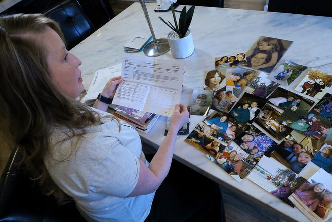 Theresa Sari looks over complaints in her Carteret, NJ, home Wednesday, April 20, 2022, that she filed over the nursing home care that was given to her mother. Her 60-year-old mother died of COVID in a Long Island nursing home.
