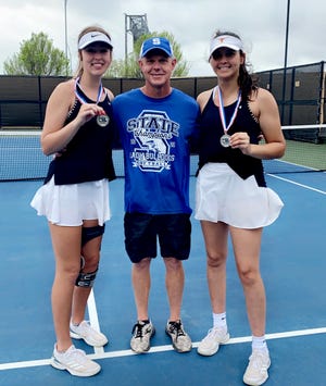 Stamford's Citlaly Gutierrez (right) poses with teammate Tylee Jo Bevel and coach Joe Crabb after finishing second place at regionals in girls doubles on April 12.