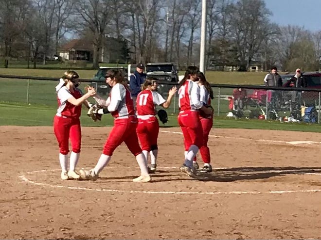 Elgin's infield meets during a recent softball game at Ridgedale. The Comets have asserted themselves atop the Northwest Central Conference standings.