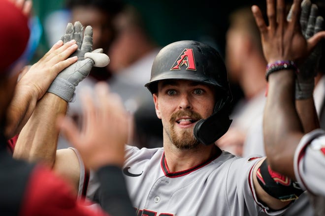 Arizona Diamondbacks' Cooper Hummel is congratulated for his two-run home run during the fifth inning of the team's baseball game against the Washington Nationals at Nationals Park, Thursday, April 21, 2022, in Washington. (AP Photo/Alex Brandon)