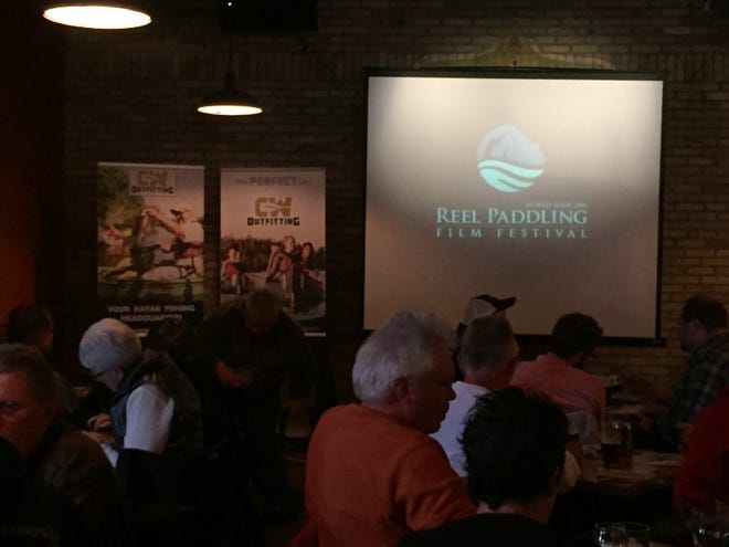 Guests take time out to watch paddling films at the local showing of the annual Paddling Film Festival World Tour.