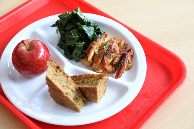 A plated lunch of roasted barbecue chicken with braised collard greens and whole wheat cornbread, representative of a Southern dish made by Red Rabbit, is pictured in the cafeteria at Dream Charter School in Harlem April 21, 2022. Due to COVID protocols, students are eating packed lunches in their classroom. Red Rabbit, a Black-owned school food services company, makes culturally competent healthy meals that kids want to eat. In doing so, they are exposing some kids to different foods and foods they eat at home for others.
