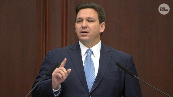 Florida Gov. Ron DeSantis, one finger away from eating some pudding, probably.