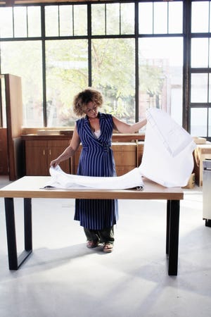 Bridgid Coulter pores over design drawings in a workspace at her Blackbird House collective in Culver City, Calif.