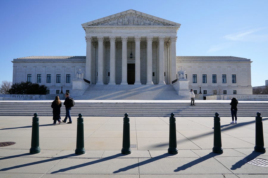 FILE - Visitors walk outside the Supreme Court building on Capitol Hill in Washington, Feb. 21, 2022. (AP Photo/Patrick Semansky, File) ORG XMIT: WX105