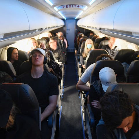 Airline passengers sit on a American Airlines flig
