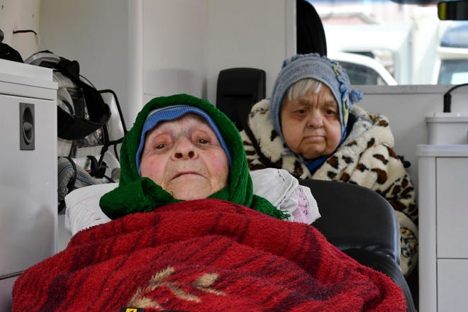 Elderly women wait in transport during an evacuation of civilians with limited mobility in Kramatorsk, Ukraine, on April 21, 2022.