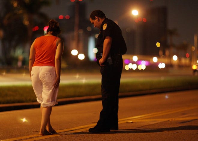 This file photo shows a City of Miami police officer conducting a field sobriety test at a DUI traffic checkpoint in Miami, Florida.