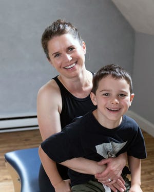 Melissa Rowell and her son, Graham, in her Pilates studio.