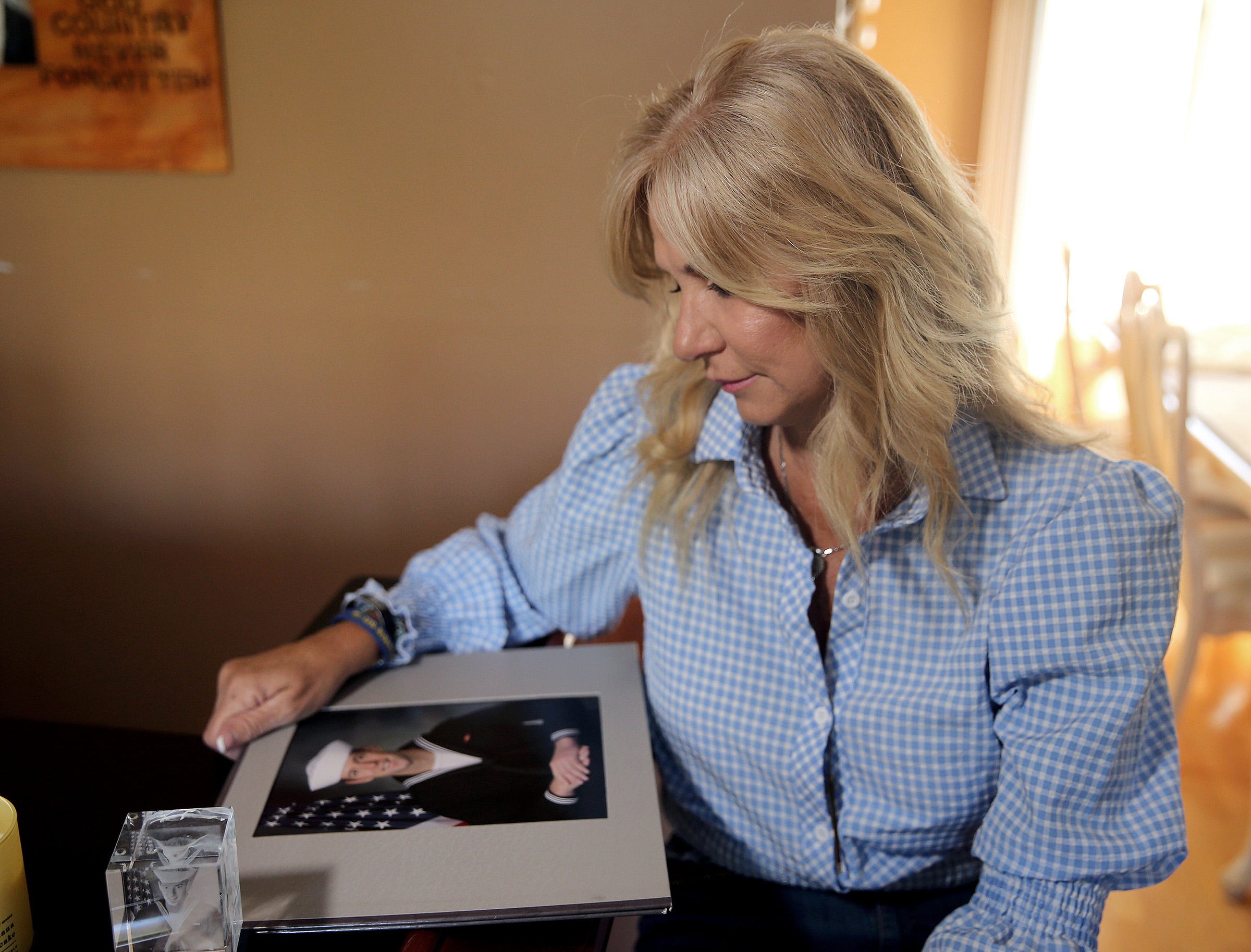 Regina Mullen looks at a photo of her son Kyle in her Manalapan home Friday, April 22, 2022. The investigation is still ongoing into how Kyle died during Navy SEAL training in February.