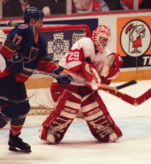Detroit Red Wing goalie Mike Vernon stops the puck with his chest as St. Louis Blues' Joe Murphy works in front of the net during Game 5 of the first round playoff series at Joe Louis Arena, April 25, 1997.