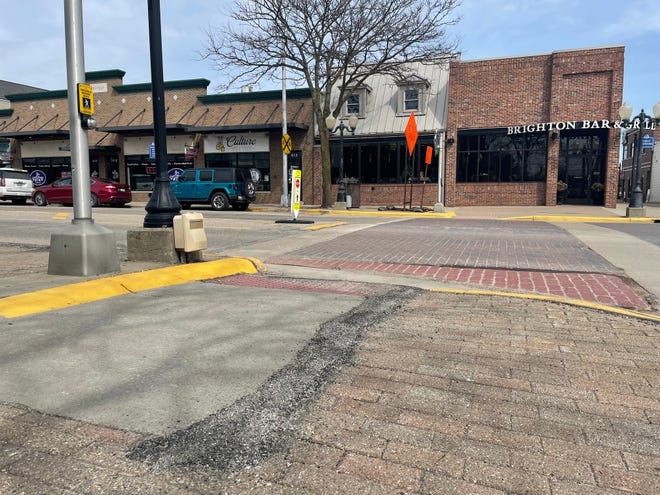 The current condition of sidewalks and a crosswalk at Main and Hyne streets in downtown Brighton is shown Friday, April 22, 2022.
