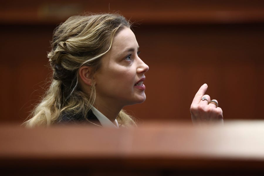Actor Amber Heard appears in the courtroom at the Fairfax County Circuit Court in Fairfax, Va., Thursday, April 21, 2022. Actor Johnny Depp sued his ex-wife Amber Heard for libel in Fairfax County Circuit Court after she wrote an op-ed piece in The Washington Post in 2018 referring to herself as a "public figure representing domestic abuse." (Jim Lo Scalzo/Pool Photo via AP) ORG XMIT: WX443