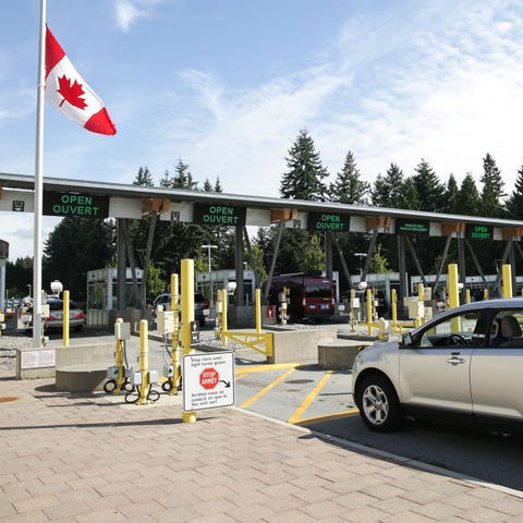 People wait in line at the US-Canada border as Can