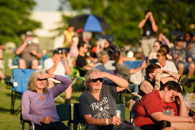 People listen to Rivermist while performing at the Dogwood Festival on Friday, April 22, 2022.