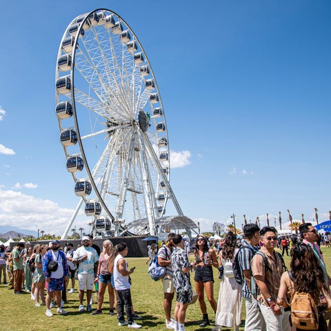 Festivalgoers stand in the merchandise line at the