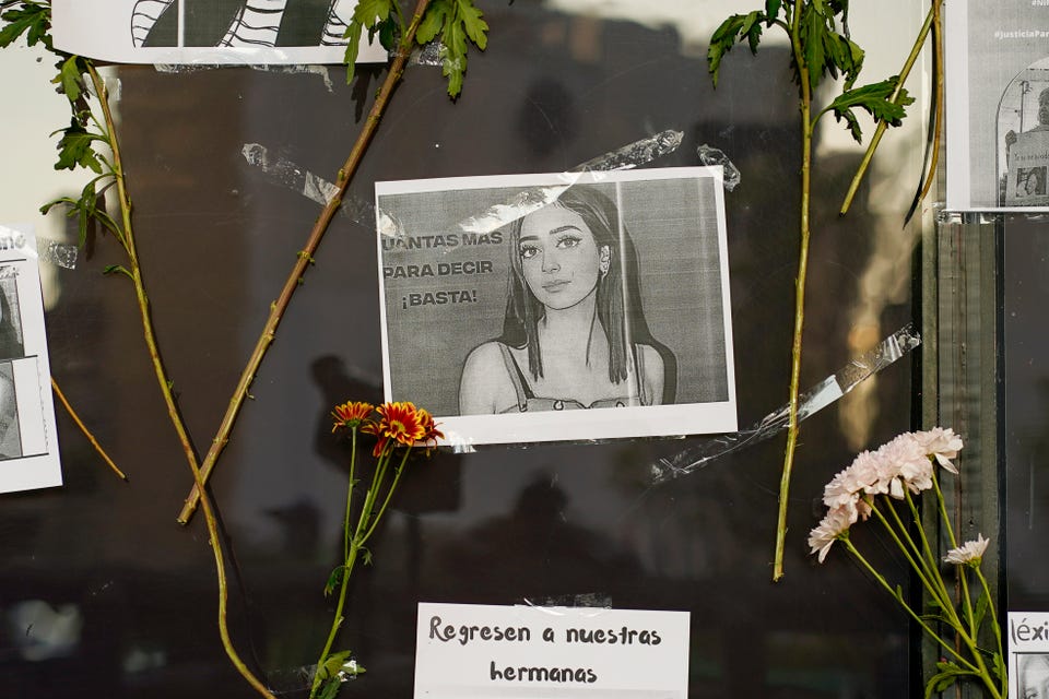 Flowers on the facade of the Attorney General's office surround an image of Debanhi Escobar during a protest against the disappearance of Escobar and other women who have gone missing, in Mexico City, Friday, April 22, 2022.