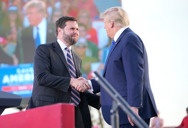 Apr 23, 2022; Delaware, Ohio, USA; JD Vance shakes hands with former President Donald Trump during a rally at the Delaware County Fairgrounds. Mandatory Credit: