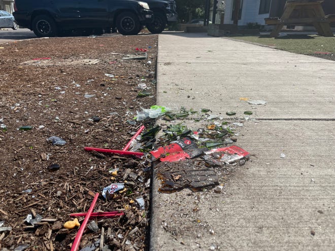The remnants of a party on 16th Avenue in Eugene includes broken glass in the street.