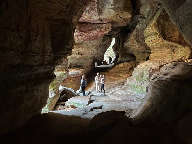 Visitors explore Rock House in Hocking Hills State Park.