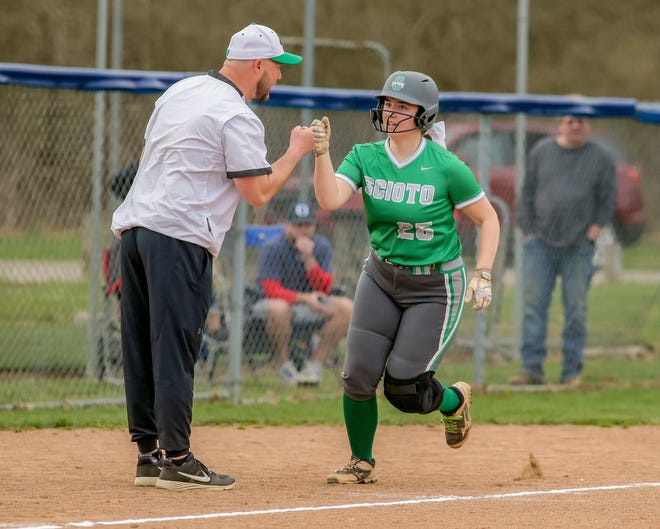 First-year Scioto coach Doug Bell fist-bumps Caroline Piatt as she trots home after hitting a home run earlier this season. Piatt is one of three senior leaders for the Irish, along with Madi Comstock and Sadie Jauregui.