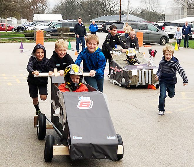 Prairie Central Elementary students try out their finished karts on the playground at PCE. It was the culmination of a project where PCE third graders, with help from Prairie Central High School students and Fairbury Speedway personnel, put together karts as class project.