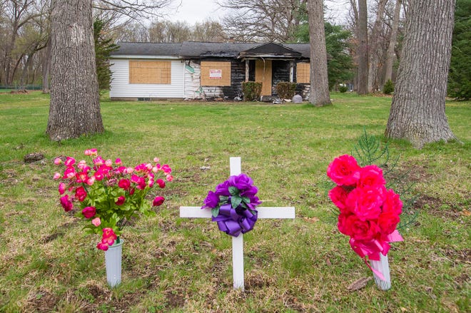 A small memorial sits in front of the scene of a fatal house fire in the 20300 block of Brick Road on Monday, April 25, 2022, in South Bend.