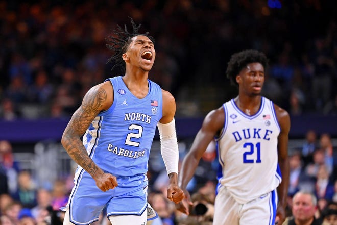 Caleb Love, left, lets out a yell and enjoys a moment as Duke’s AJ Griffin looks on during North Carolina’s defeat of the Blue Devils in the Final Four at Caesars Superdome in New Orleans.