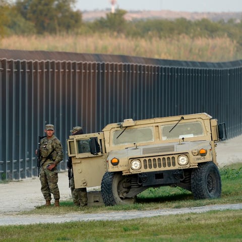 National Guardsmen stands watch over a fence near 