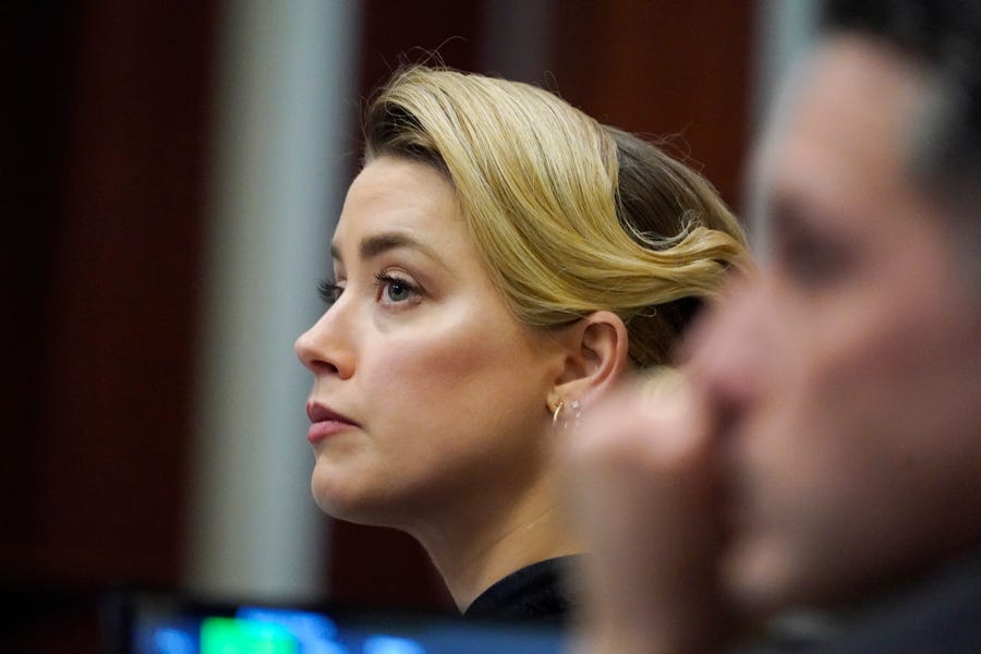 Actress Amber Heard listens in the courtroom at the Fairfax County Circuit Courthouse in Fairfax, Va., Monday, April 25, 2022. Actor Johnny Depp sued his ex-wife Amber Heard for libel in Fairfax County Circuit Court after she wrote an op-ed piece in The Washington Post in 2018 referring to herself as a "public figure representing domestic abuse." (AP Photo/Steve Helber, Pool) ORG XMIT: VASH316