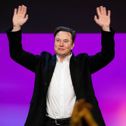 Tesla chief Elon Musk waves onstage at the TED2022