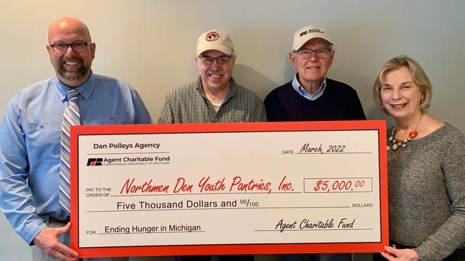 Pictured from left: Farm Bureau Insurance agent Dan Polleys, Bill McMasters of Bill’s Farm Market, Ben Blaho of the Emmet County Farm Bureau Board, and the executive director of the Northmen Den Youth Pantries Kathy Peterson.