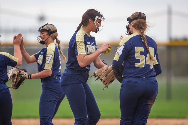 New Prairie's Ava Geyer high fives teammates after a strikeout during the New Prairie vs. Marian softball game Monday, April 25, 2022 at Marian High School. 