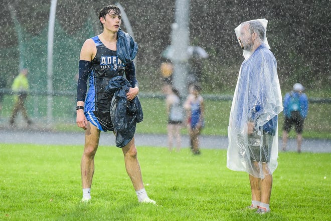 Adena’s Ryan Richendollar talks with Westfall cross country and track coach Austin Ridenour after a rainy race at the Huntington Track Invitational on April 25, 2022.