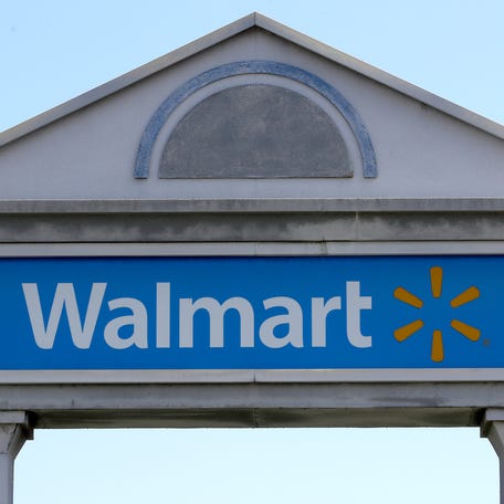In this Sept. 3, 2019, file photo, a Walmart logo forms part of a sign outside a Walmart store, in Walpole, Mass.