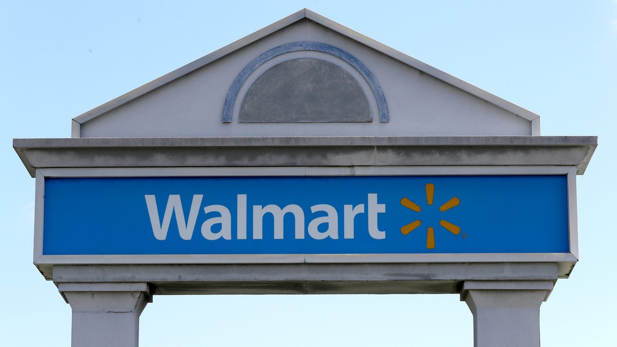 In this Sept. 3, 2019, file photo, a Walmart logo forms part of a sign outside a Walmart store, in Walpole, Mass.