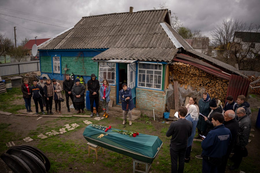 April 26, 2022: Relatives of Mykola Moroz, 47, gather during a funeral service at his home in the Ozera village, near Bucha, Ukraine. Mykola was captured by the Russian army from his house in the Ozera village on March 13, taken for several weeks in an unknown location, and finally found killed by gunshots about 15 kilometers from his house.
