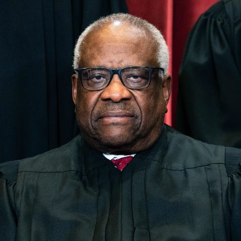 FILE - Justice Clarence Thomas sits during a group