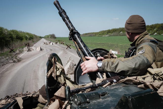 A Ukrainian soldier sits on a armoured personnel carrier on a road near Slovyansk, eastern Ukraine, on April 26, 2022.
