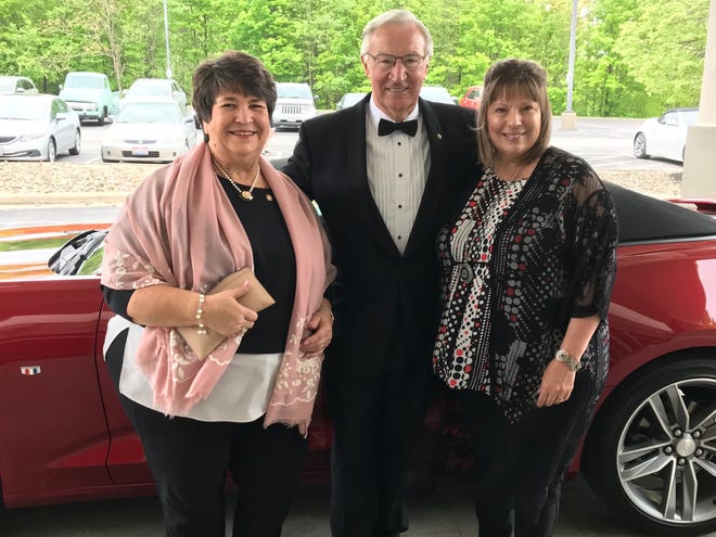 Pictured are Gala Co-Chairs Marilyn Orr (left) and Kris Barker with Past President Ron Strobl and an item from the Camaro Auction at the final Rotary Gala.