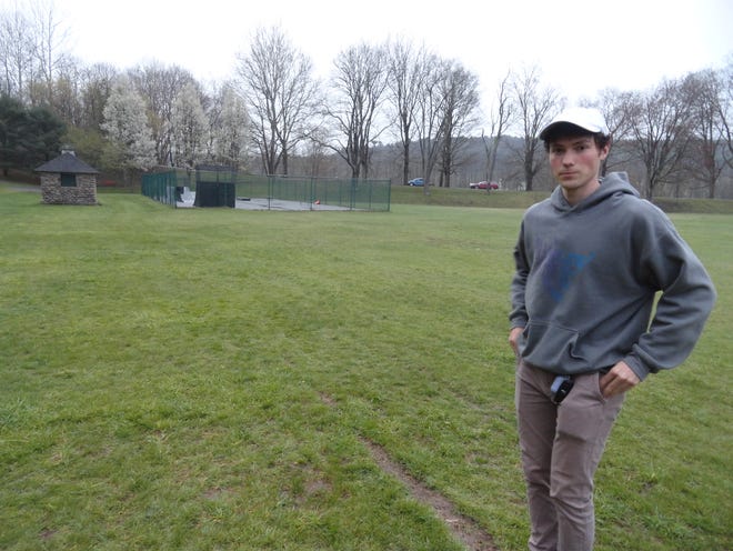 Franklyn Paul, 21, stands at the where the corner would be to a proposed 125 by 65-foot addition to the original skatepark, seen in the background in Bingham Park, Hawley. The original skateboarding facility is 100 by 50 feet. To the left of the skatepark is one of two cobble-stone pool houses constructed in the early 1930's when Bingham Park was being constructed and a swimming pond existed where the skatepark is now. Park Place, lining a rim of the 19th century canal basin that later became the park, is seen in the distance.