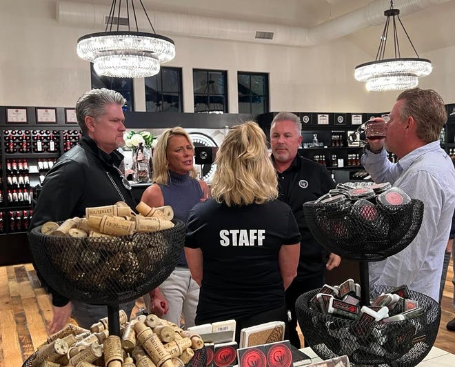 Scott Swaldo, CEO and Managing Director of GV Destination, second from the right, talks with guests at the recent reopening of Gervasi Marketplace, an expanding store offering wine, spirits, clothing, wallets, homeware, coffee beans, candles and more.