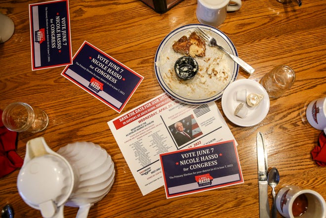 Campaign fliers and empty cups and plates are left on the table after the Westside Conservative Club met on Wednesday, April 27, 2022, at the Machine Shed in Urbandale, Iowa.
