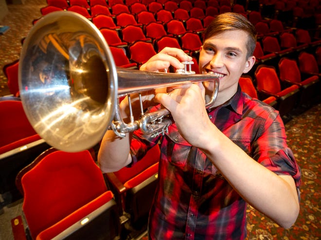 Manitowoc Lincoln High School's Joey O' Connor poses with his trumpet in the auditorium, Wednesday, April 27, 2022, in Manitowoc, Wis. O'Connor has left his mark on music in the school and hopes to build on that legacy.